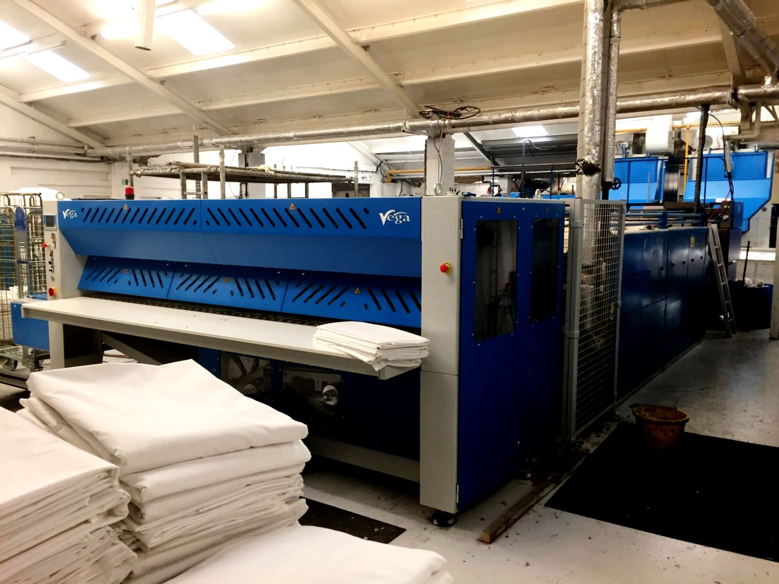Industrial flatwork ironer processing hotel linens